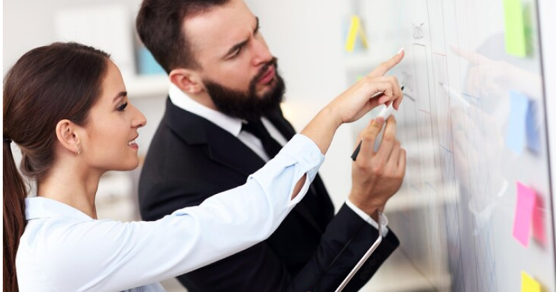 two co-workers discussing business matters