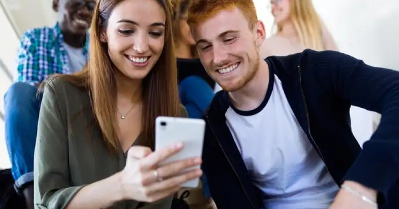 boy and girl checking phone together