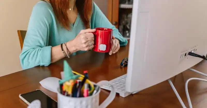 person drinking from a mug
