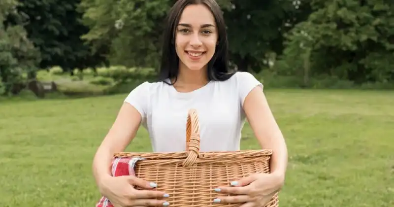a girl holding a picnic basket