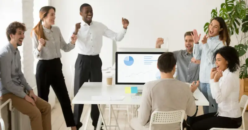 team members celebrating success at work