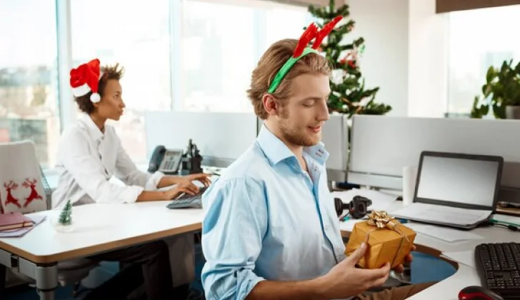 Two employees opening Christmas Gifts