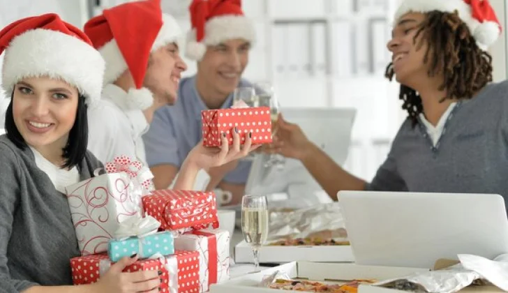 Co-workers exchanging gifts to each other