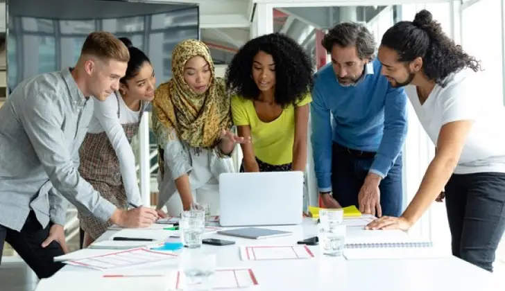a group of co-workers working in the office