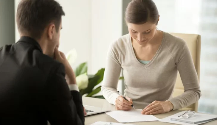 an employee signing a contract