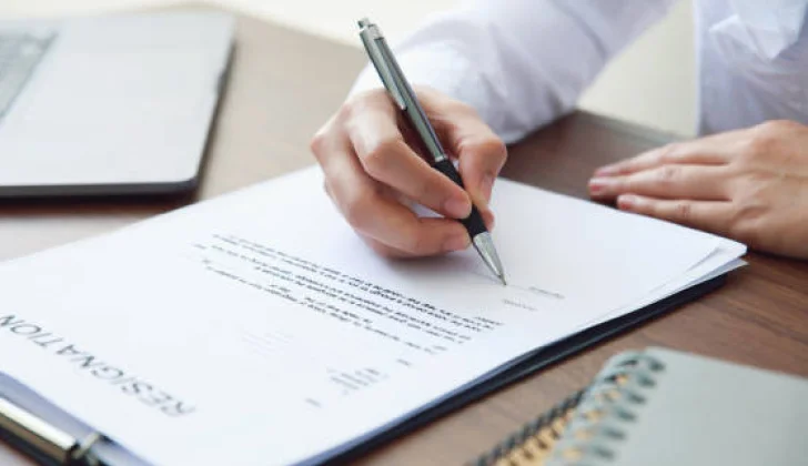 a person signing a resignation letter