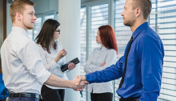 an employee and employer shaking hands