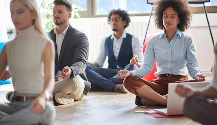 some employees meditating at workplace