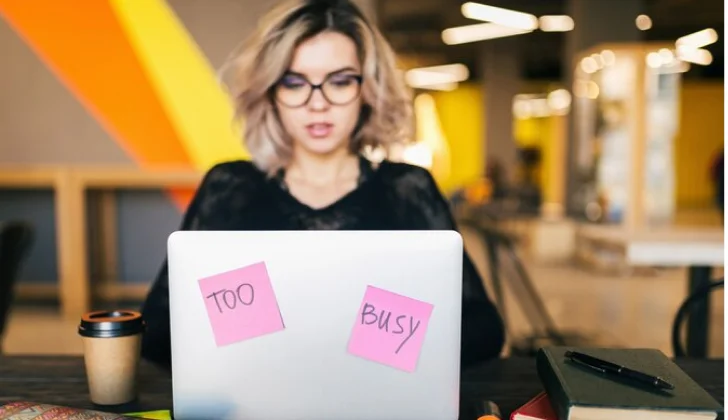 a girl working behind her laptop