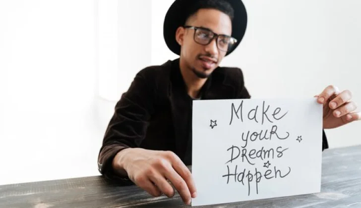 a guy holding a quote
