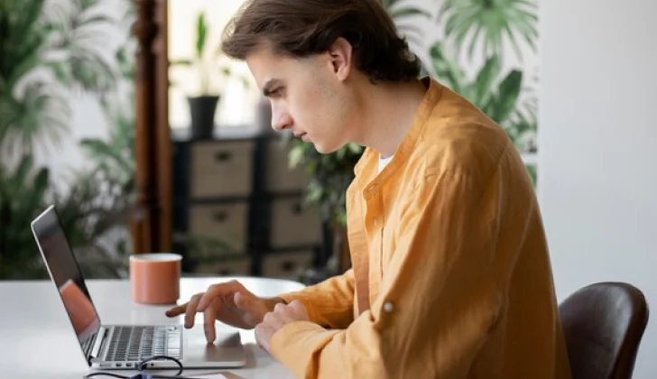 a guy searching on laptop