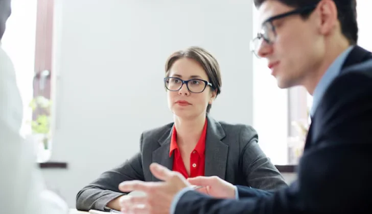 employer and employees having a meeting