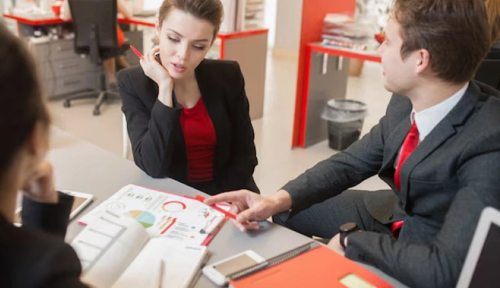 three employees discussing a project
