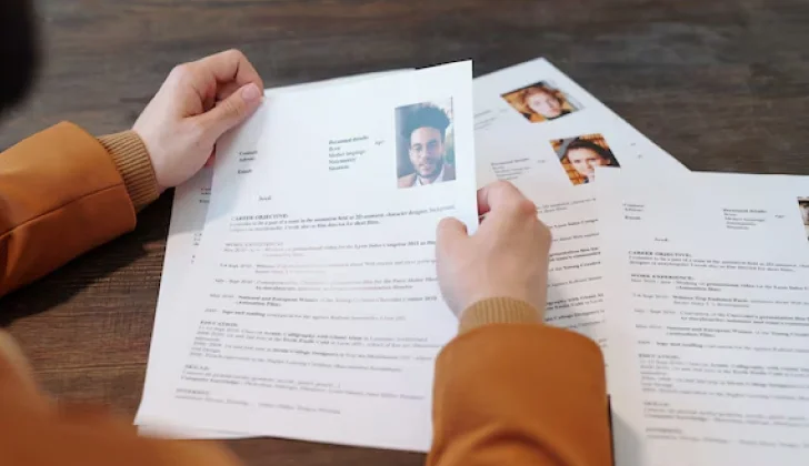 an employer checking many resumes