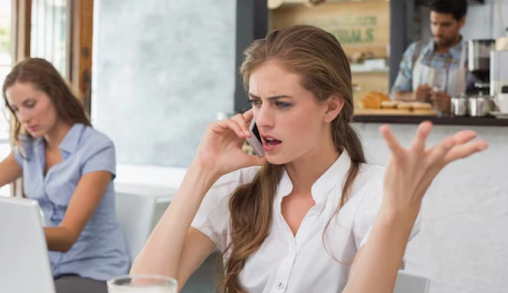 an angry employee talking on the phone