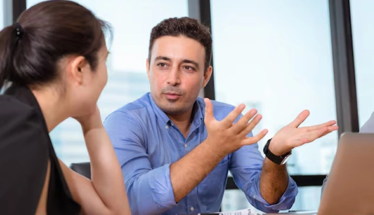 an employee explaining a task to others