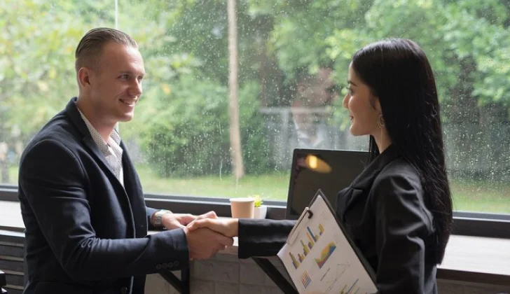 a manager and employee shaking hands