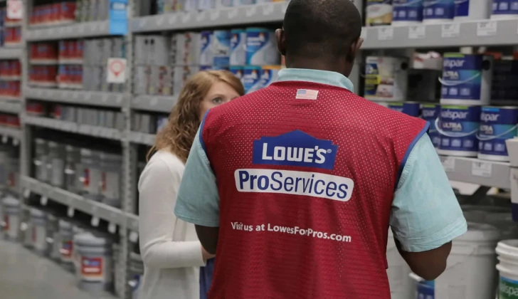 a Lowe's employee helping a customer