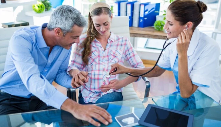a doctor checking a pregnant woman