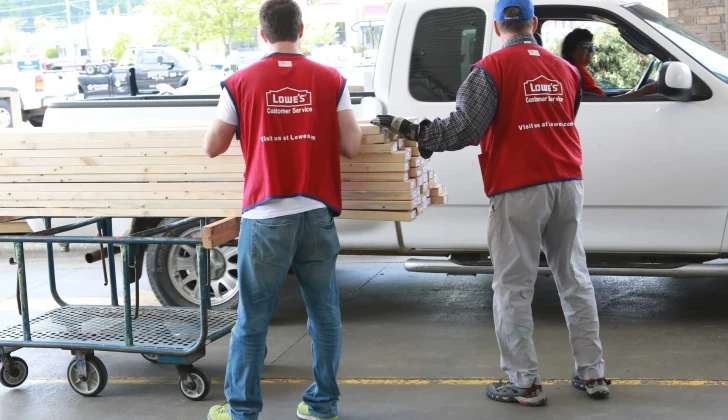 two Lowe’s Employees unloading woods