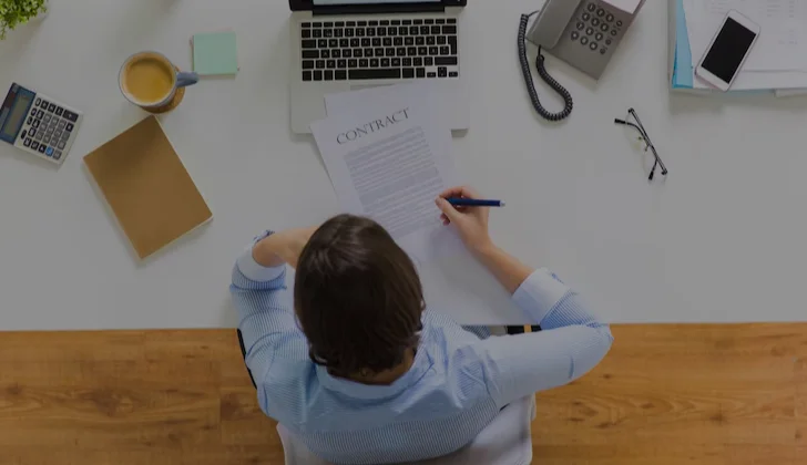 a person writing a contract