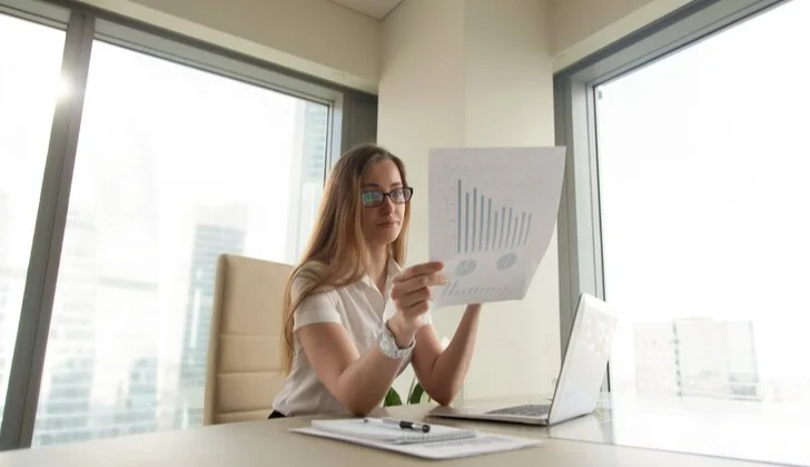 a woman checking monthly reports
