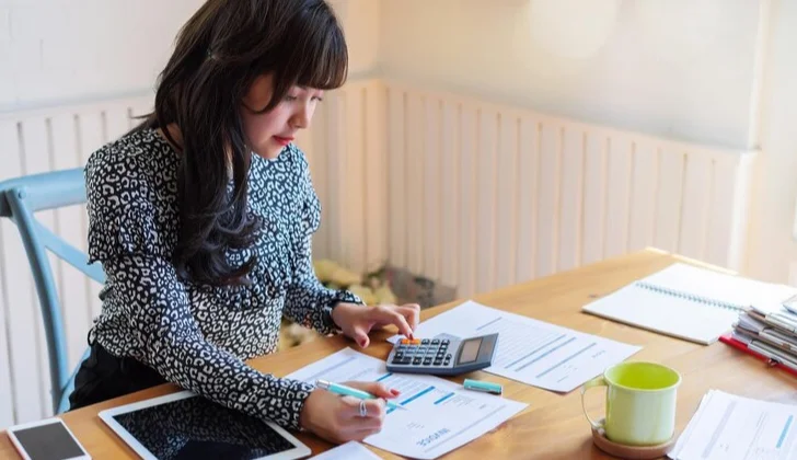 a woman using a calculator