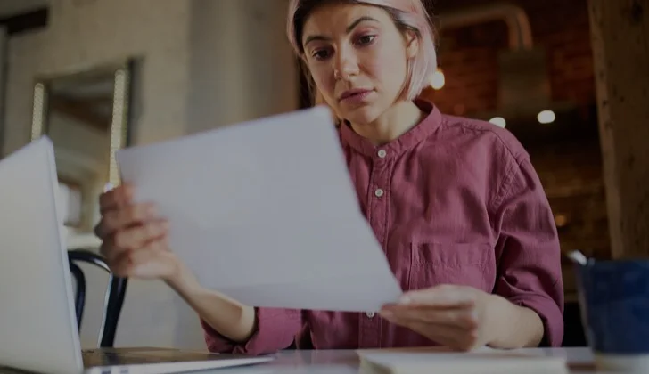 a woman reading a letter