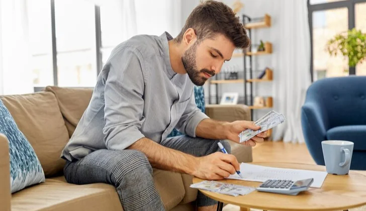 a man writing down a documents