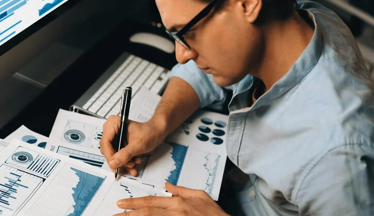 an employee analyzing data