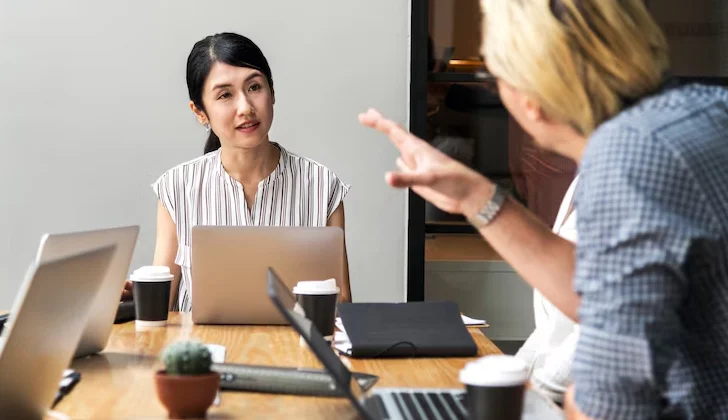 two employess talking