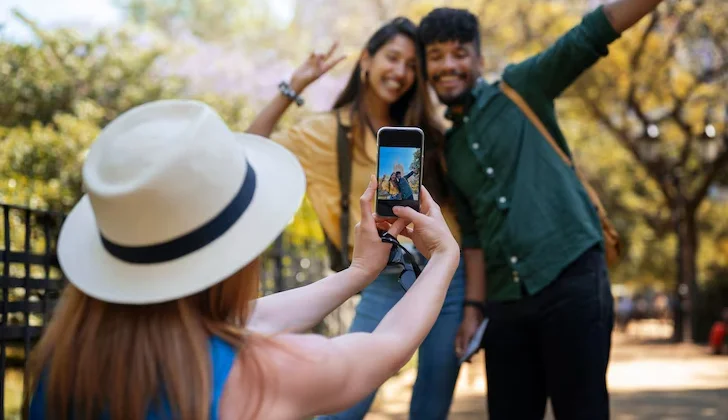 a person taking picture from a couple