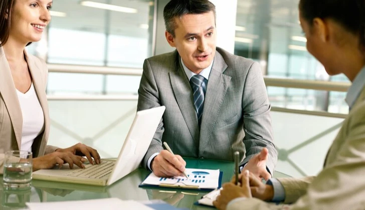 an employer having a meeting with employees