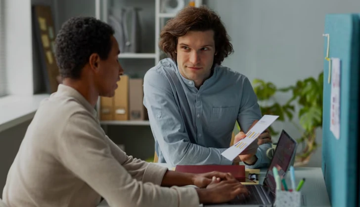two employees checking a project