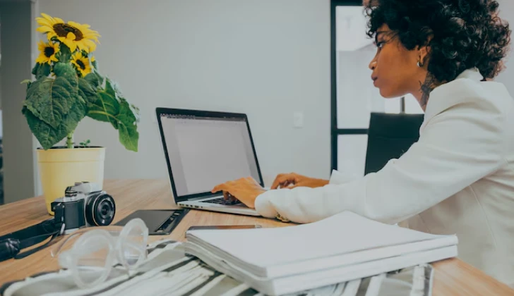 an employee typing behind laptop