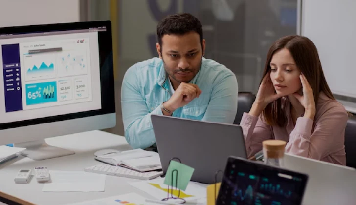 two employees checking a task