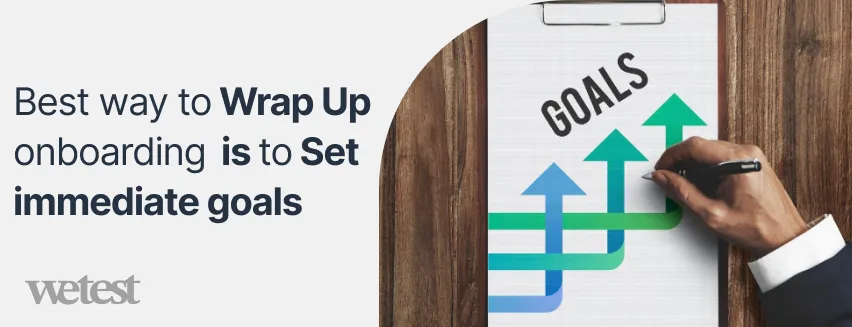 A man writing on a notepad with the word Goals on it