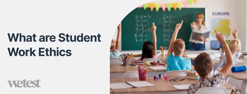 A classroom, multiple students have raised their hands